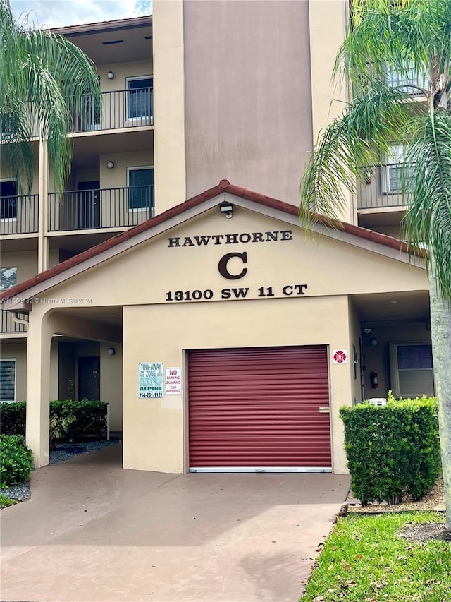 view of building exterior with a garage and concrete driveway