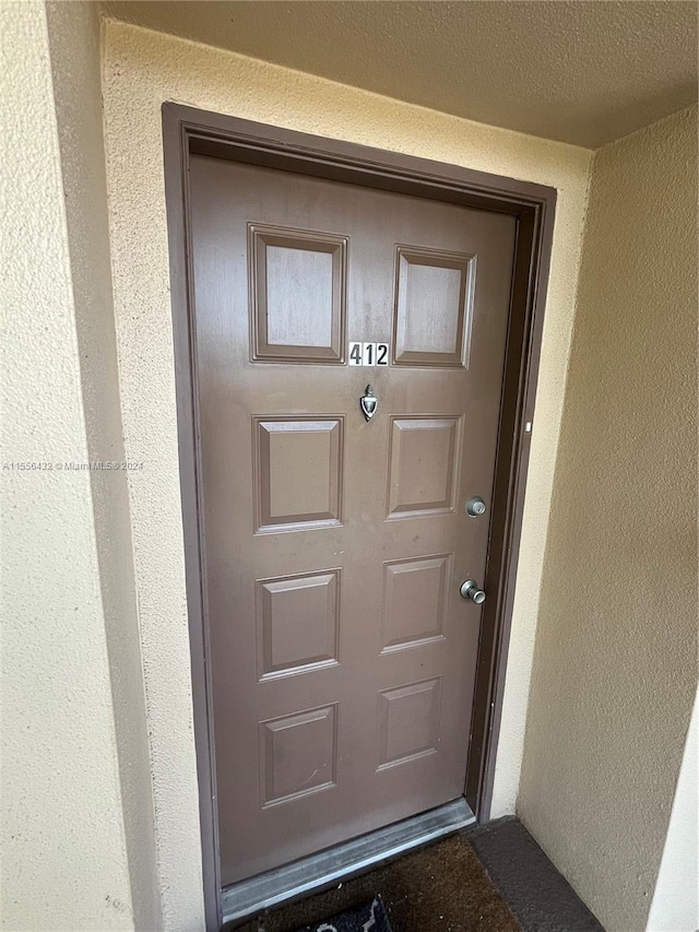 entrance to property with stucco siding