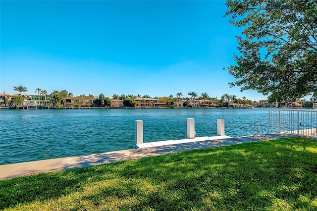 dock area featuring a water view and a lawn