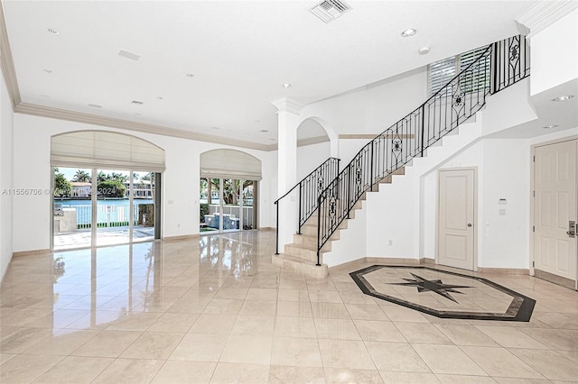 entryway with ornamental molding, recessed lighting, visible vents, and baseboards