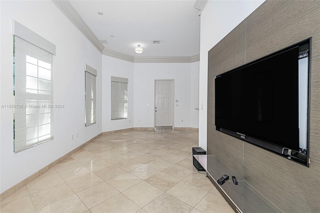 unfurnished living room with crown molding and light tile patterned floors