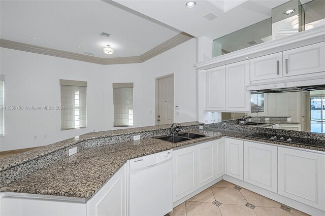 kitchen with white cabinets, dishwasher, dark stone counters, and sink