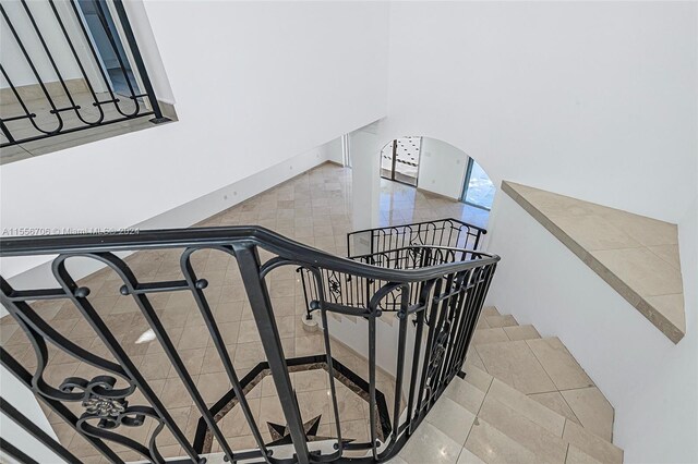 stairway with light tile patterned flooring