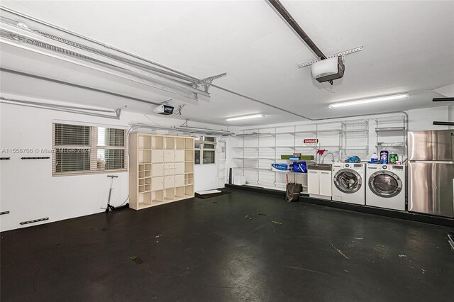 garage featuring stainless steel fridge, separate washer and dryer, and a garage door opener