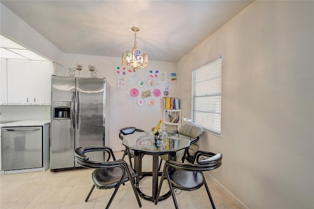 tiled dining area with a chandelier