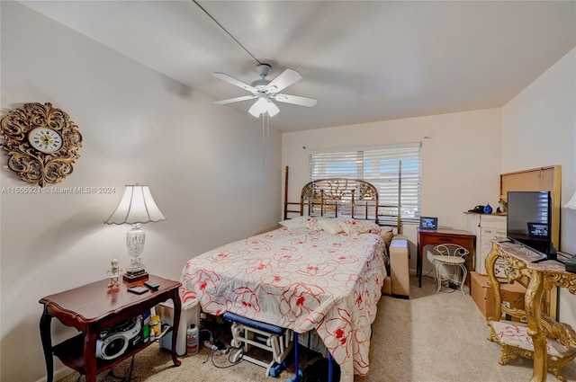 bedroom with ceiling fan and light carpet