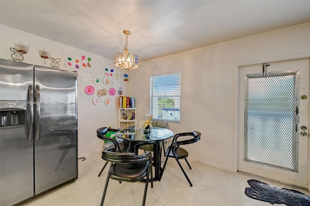 tiled dining area featuring a chandelier