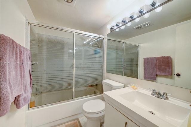 full bathroom with tile patterned flooring, vanity, toilet, and bath / shower combo with glass door