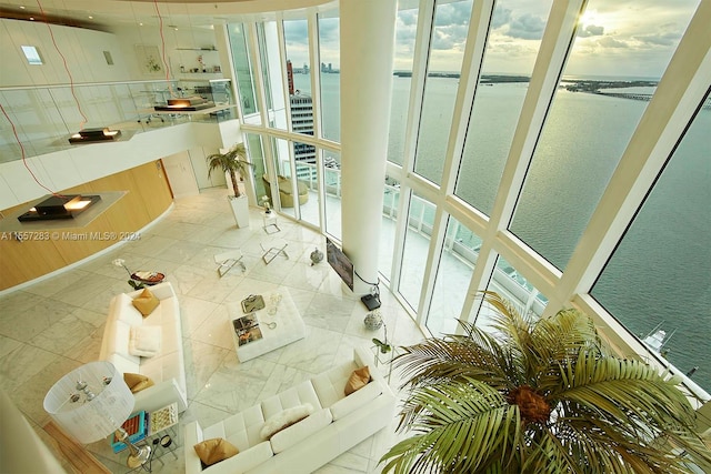 interior space featuring a water view and light tile flooring