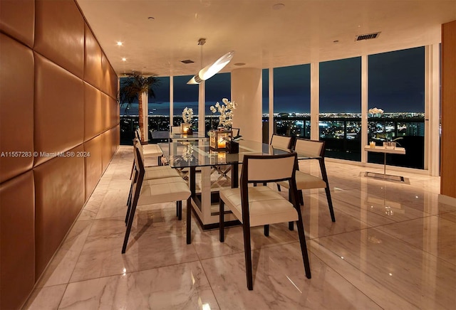 tiled dining area featuring a water view