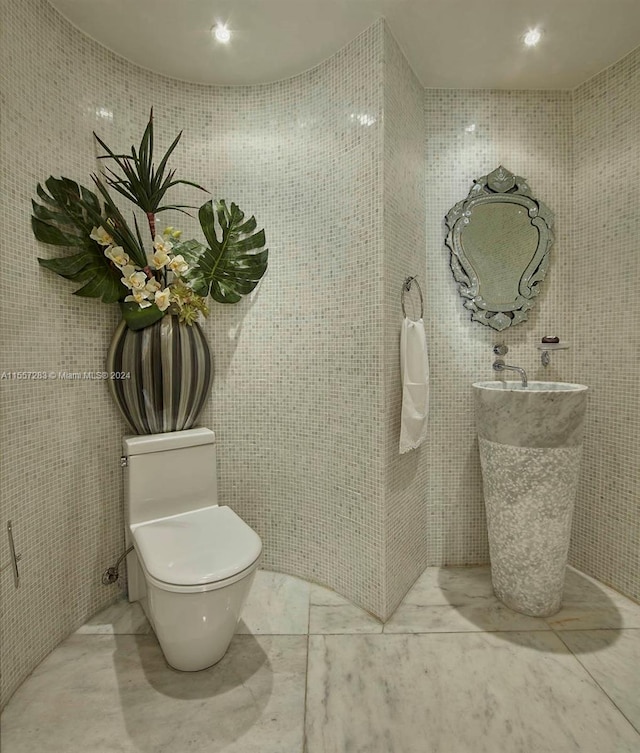 bathroom with toilet and tile floors