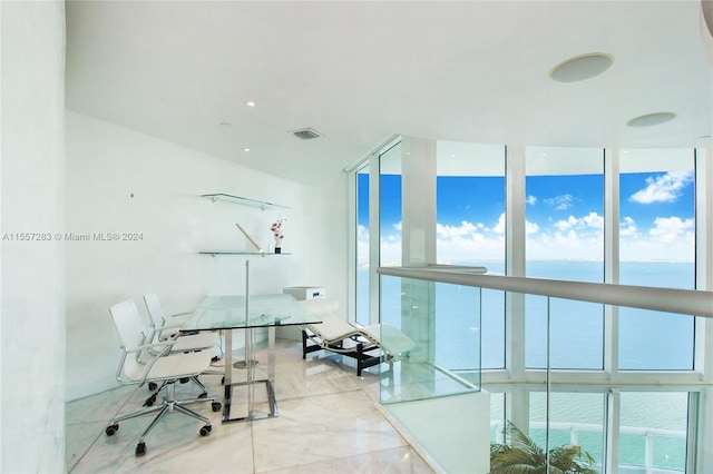 office area with expansive windows and a water view