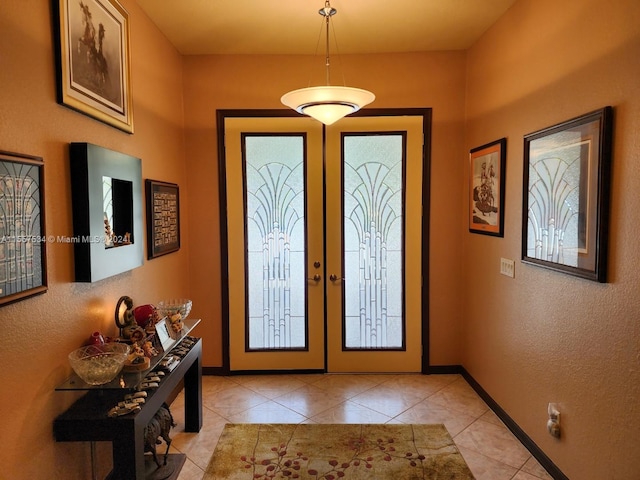 tiled foyer entrance featuring french doors