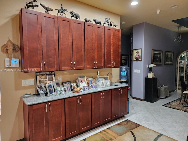 kitchen with light tile floors and light stone counters