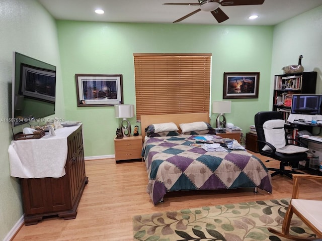 bedroom with light hardwood / wood-style floors and ceiling fan