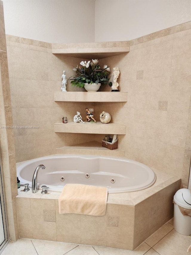 bathroom featuring a relaxing tiled bath and tile flooring