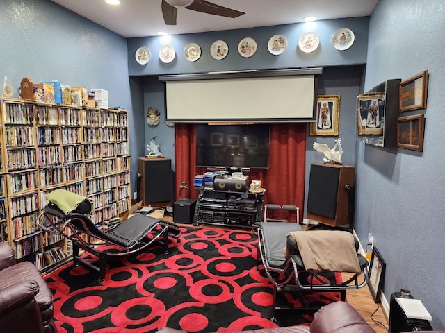 living room with wood-type flooring and ceiling fan