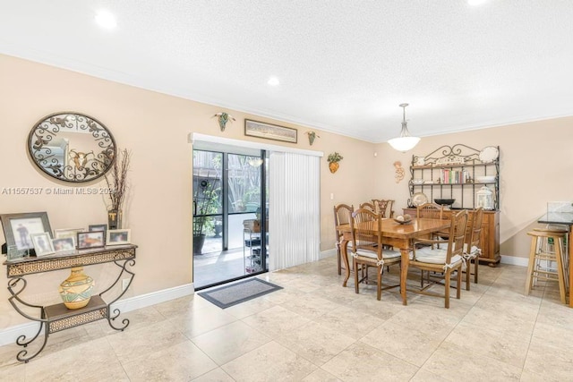 dining room with light tile floors, a textured ceiling, and crown molding