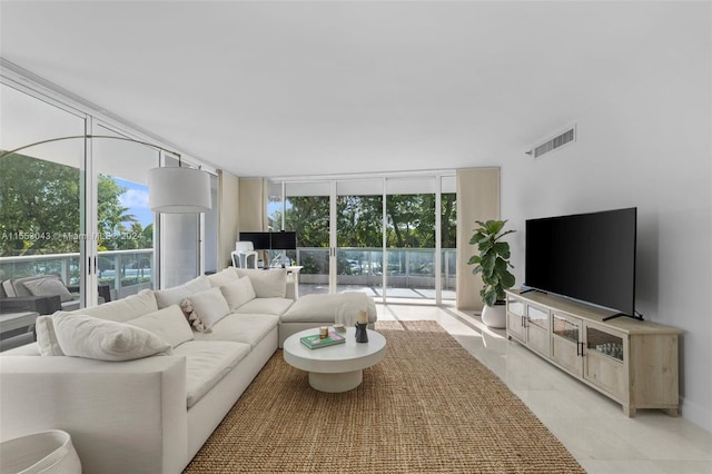 living room featuring light tile floors and expansive windows