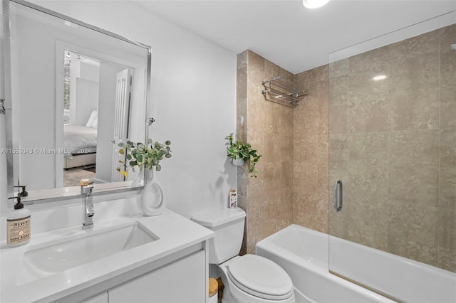 full bathroom featuring vanity, shower / bath combination with glass door, and toilet