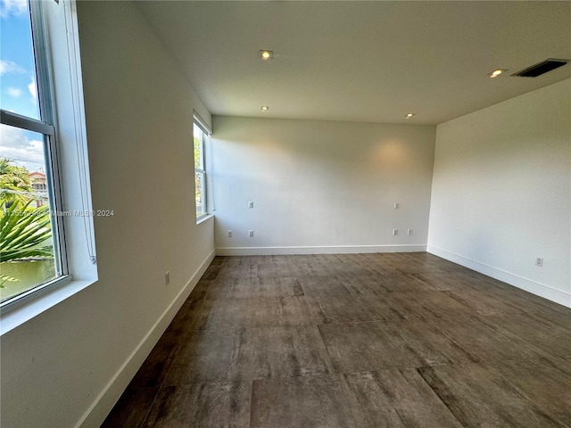 unfurnished room featuring dark hardwood / wood-style flooring