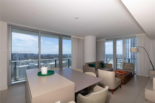 dining area with light tile floors and a wall of windows