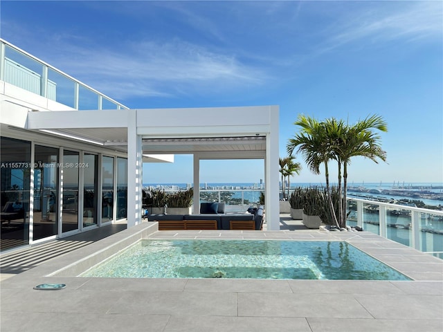 view of swimming pool with a water view and an outdoor living space