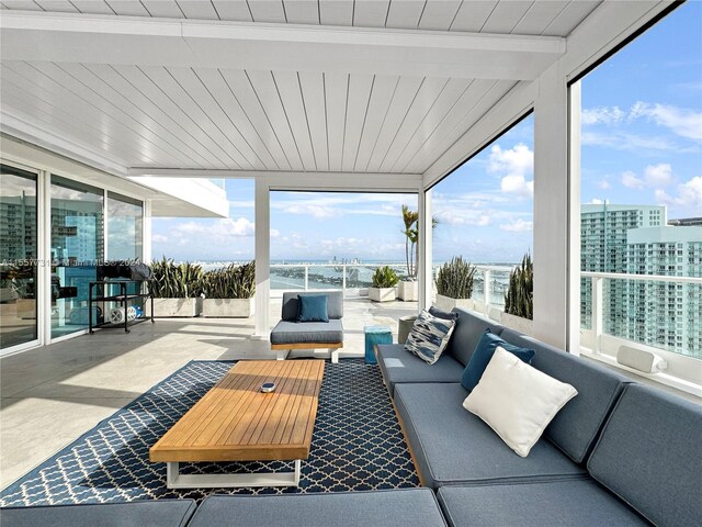 view of patio with outdoor lounge area and a balcony