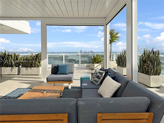 interior space featuring wood ceiling, a healthy amount of sunlight, and a water view