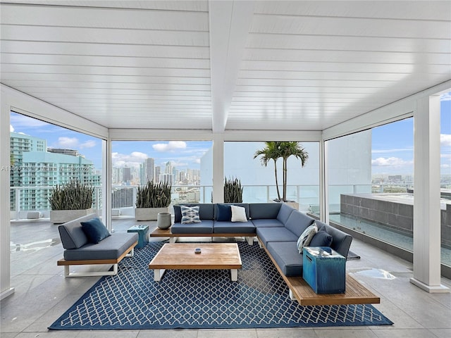 sunroom featuring beamed ceiling