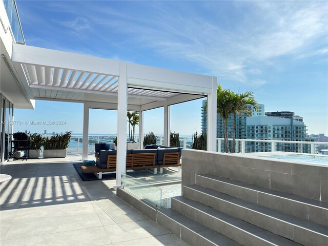 view of patio / terrace with a water view and an outdoor hangout area