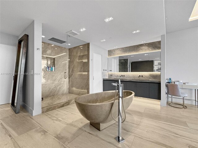 bathroom with vanity and plus walk in shower