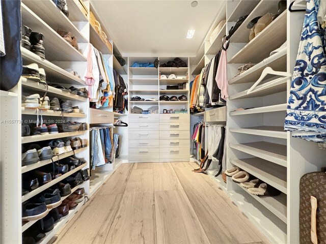 spacious closet featuring light hardwood / wood-style floors