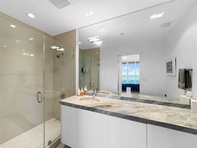 bathroom with vanity and a shower with shower door