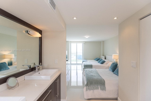 bathroom featuring vanity, tile floors, and a wall of windows