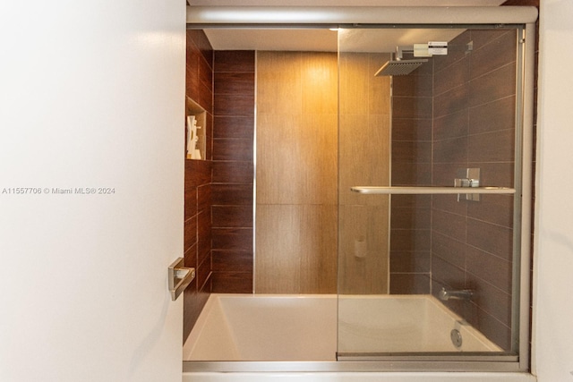 bathroom featuring shower / bath combination with glass door