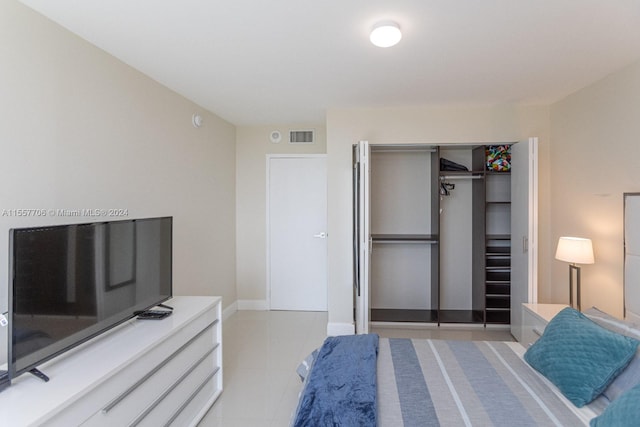 tiled bedroom featuring a closet