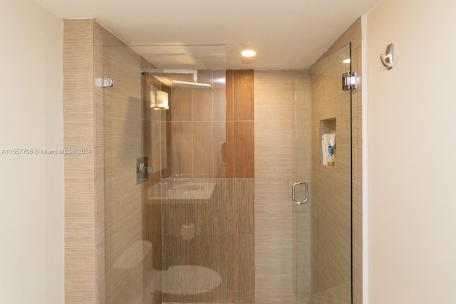 interior details featuring a shower with shower door