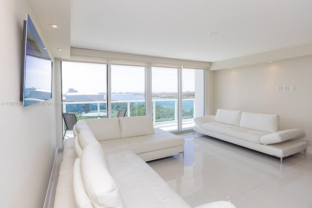 tiled living room featuring a water view