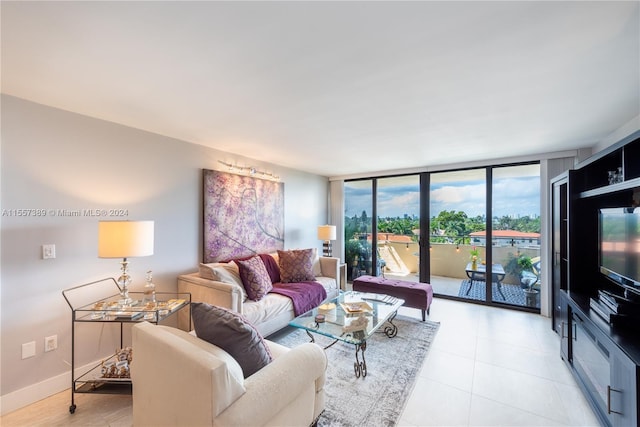 living room featuring light tile flooring and a wall of windows