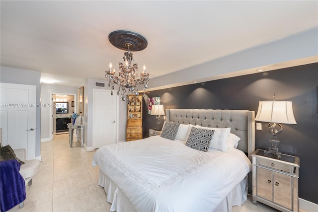 bedroom featuring an inviting chandelier and light tile floors