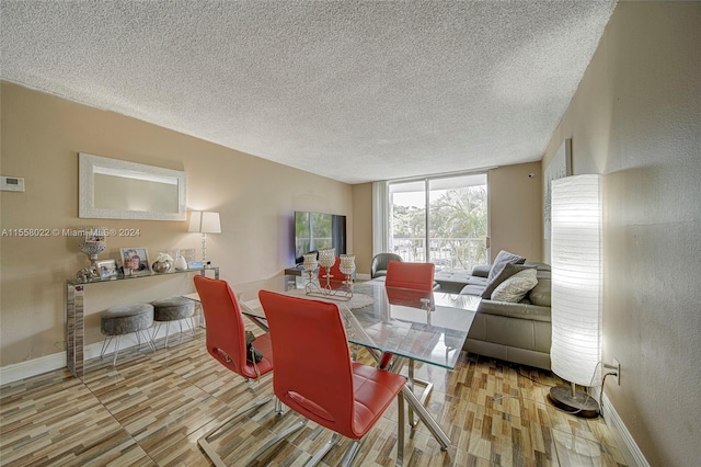 dining room featuring light hardwood / wood-style flooring and a textured ceiling