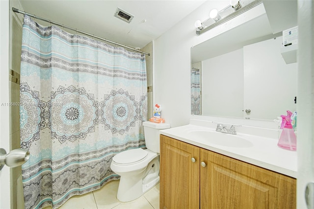 bathroom with tile flooring, vanity, and toilet