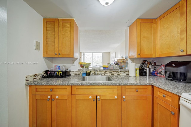 kitchen featuring white stove and sink