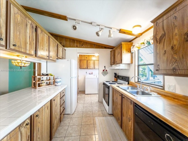 kitchen with light tile floors, vaulted ceiling, white appliances, washer / dryer, and track lighting