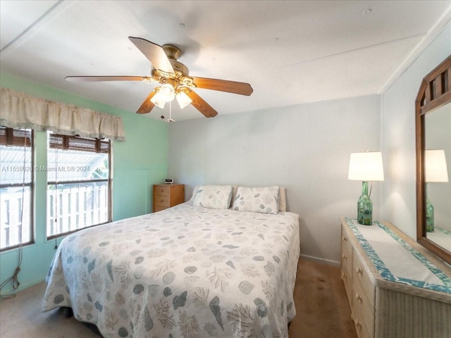 bedroom with dark colored carpet and ceiling fan