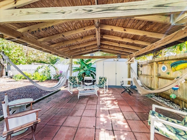 view of patio with a storage shed