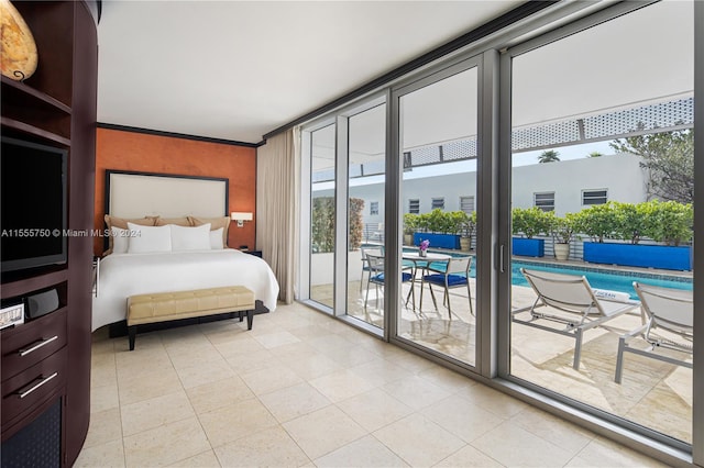 bedroom with ornamental molding, access to outside, light tile floors, and multiple windows