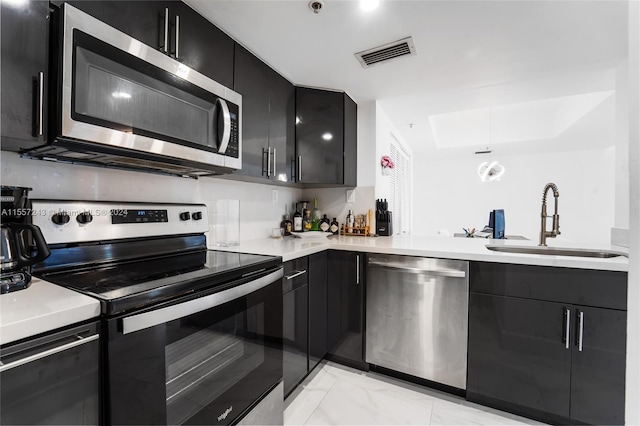 kitchen featuring appliances with stainless steel finishes, sink, and light tile flooring