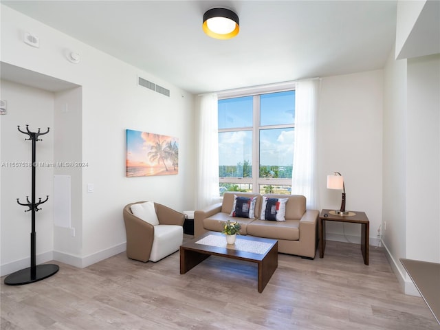 living room with light hardwood / wood-style floors and floor to ceiling windows